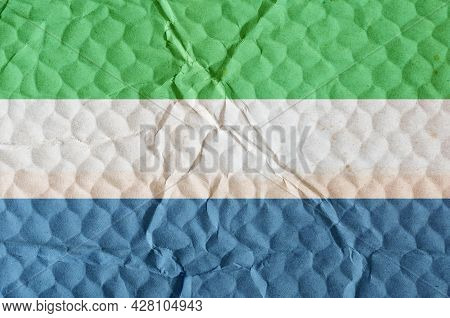 The White-blue-green Tricolor Republic Of Sierra Leone
On An Uneven Textured Surface. The National F