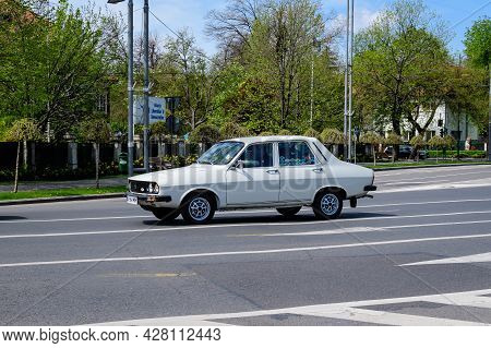 Bucharest, Romania, 24 April 2021 Old Retro White Romanian Dacia 1310 Classic Car In Traffic In A St