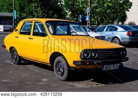 Bucharest, Romania - 5 June 2021: Old Retro Vivid Yellow Orange Romanian Dacia 1300 Classic Car Park