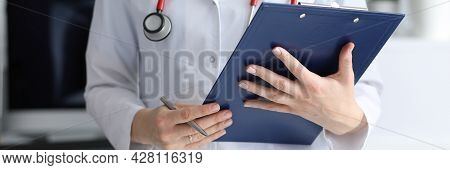 Woman Doctor Holding Clipboard With Documents In Her Hands Closeup