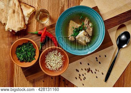 Georgian Beef Khashi Soup With Garlic Sauce, Greens, Shotis Puri And Chacha