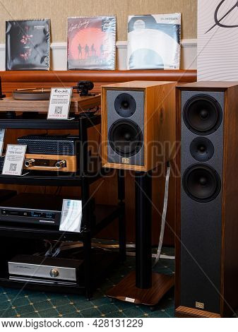 Moscow, Russia - May 23, 2021: Cayin Tube Stereo Amplifiers, Arcam Network Player, Old School Booksh