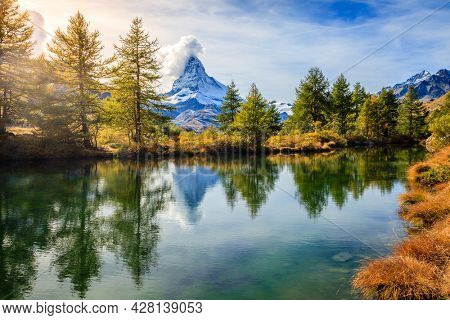 Famous alpine peak Matterhorn refleced in a pond in Swiss Apls