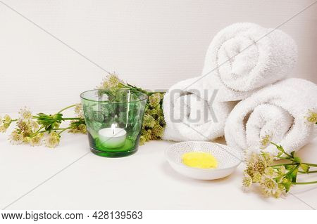 Cosmetic Moisturizer Or Emollient For Pedicure And Soft Foot Skin, White Towels, Candle And Some Gre