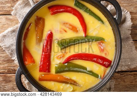 National Dish Of Bhutan Ema Datshi Closeup In The Pan On The Table. Horizontal Top View From Above