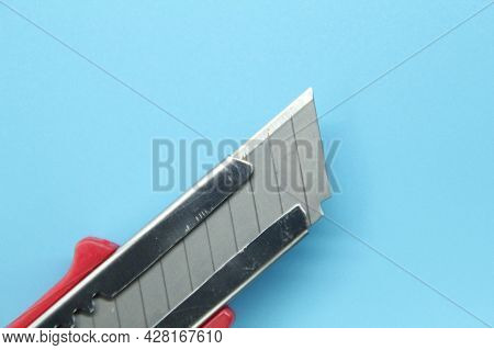 Paper Cutting Knife With A Blue Background