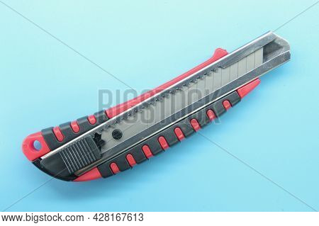 Paper Cutting Knife With A Blue Background