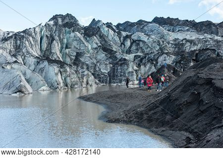 Tourists Hiking At Solheimajokull Glacier, Iceland