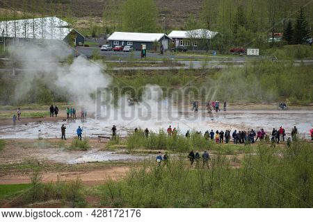 Tourists Visiting Strokkur Geyser In Iceland