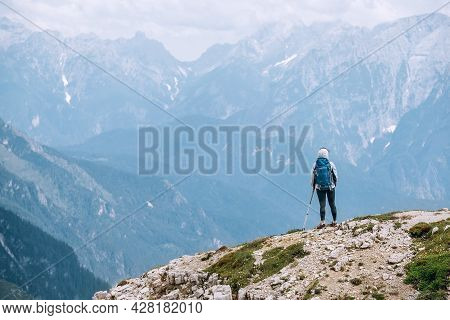 Backpacker Woman With Backpack Enjoying The Turquoise Lago Di Sorapiss 1,925m Altitude (mountain Lak