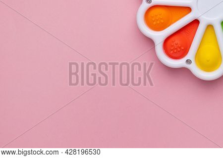 Presses With A Finger Anti-stress Toy Pop It On Pink Background. Colorful Silicone Poppit Toy, Bubbl