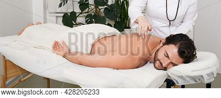 Reflexology. Treatment Of Back Pain And Tightness With Acupuncture Needles For A Male Patient