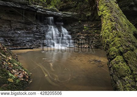 A Large Waterfall Over A Body Of Water
