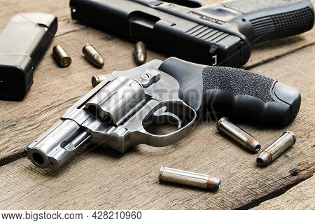 .357 Magnum Revolver, 9mm Pistol, Bullets And, Magazines On Wooden Table
