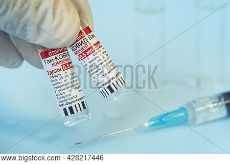 The Vaccine Sputnik V From The Coronovirus Infection Covid 19 On A Blue Background And A Syringe On 