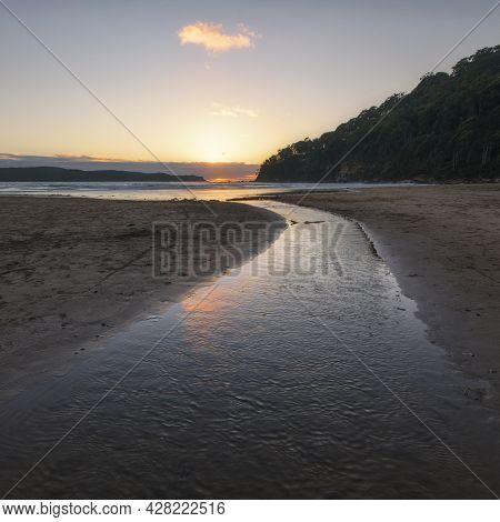 A Sunset Over A Body Of Water