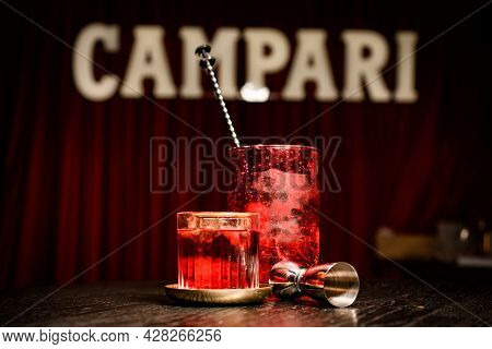 Close-up Of Glass With Cold Cocktail And Mixing Cup And Jigger On Table