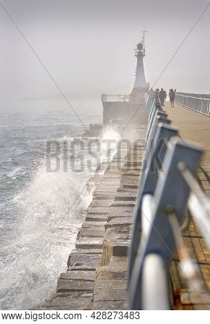 Ogden Point Lighthouse Fog. A Foggy Day As Waves Crash Against The Ogden Point Breakwater And Lighth