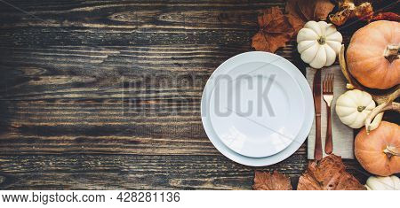 Banner Of Holiday Place Setting With Plate, Napkin, And Silverware On A Thanksgiving Day Decorated T