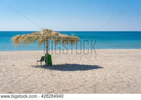 Beach Umbrela On Sandy Beach, Mediterranean Sea, Calabria Italy.