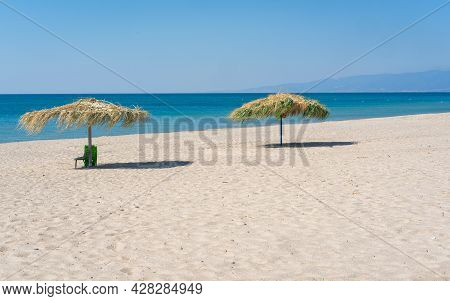 Two Beach Umbrela On Sandy Beach, Mediterranean Sea, Calabria Italy.