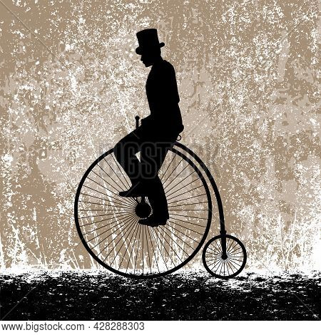 A Gentleman In A Top Hat On A Vintage High Bicycle Against The Background Of The Grunge Texture Of T