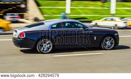 Moscow, Russia - July 2021: Rolls Royce Wraith Black With Silver Roof Driving In The Cityscape