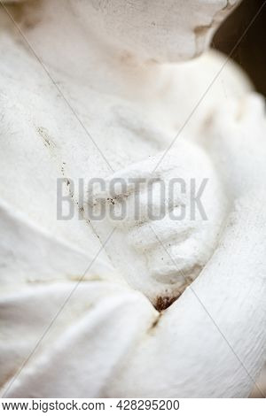 Hands On The Chest. Old Sculpture Of The Young Girl. Close-up.