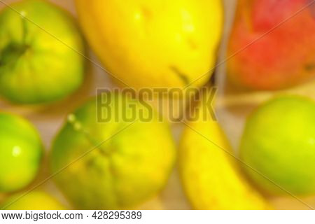 Blurred Background Of Fruits On The Table, Mango, Banana, Papaya, Tangerine And Lemon. Fruits With P