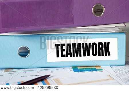 A Lignt Blue Folder With The Label Teamwork.