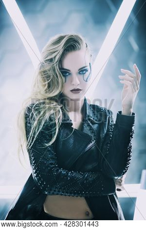 Portrait of an attractive sci-fi cyborg girl among neon lamps. . Cyberpunk concept. Make-up and hairstyle.