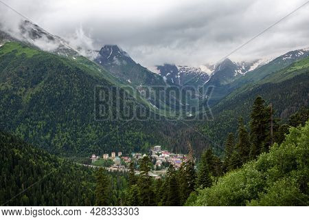 Mountain Landscape On A Summer Day. A Small Town In The Valley. Ski Resort-dombay, Russia, Karachay-