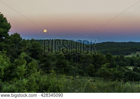 Sunrise In The Sierra De Mariola Natural Park With A Full Moon.