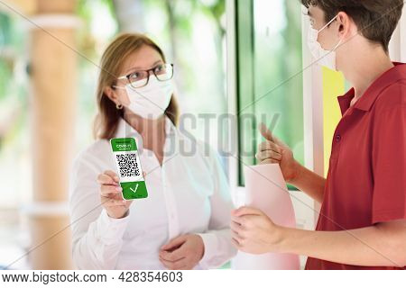 Digital Covid-19 Vaccination Certificate On Mobile Phone. Coronavirus Vaccinated People Scan Qr Code