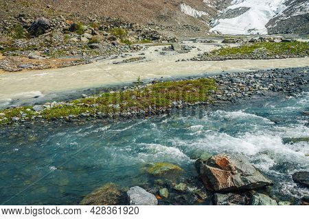 Sunny Alpine Landscape With Confluence Of Two Various Mountain Rivers. Beautiful Clear Creek Flows I