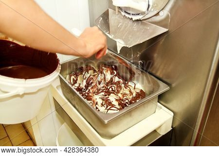 Woman Working At Ice Cream Factory Is Decorations Of Creamy Vanilla Ice Cream With Chocolate Dressin