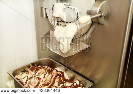 Ice Cream Making Machine Produces Vanilla Ice Cream With Chocolate Dressing And It Falls Into Steel 