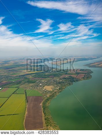 Land View Through The Airplane Window. Fields, Roads, Rivers From A Bird's Eye View. Porthole. Look