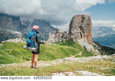 Backpacker Woman With Backpack And Trekking Poles Enjoying The Turquoise Lago Di Sorapiss 1925m Alti