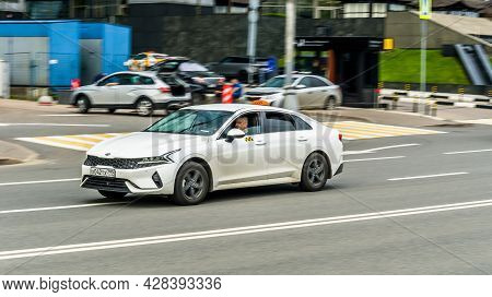 Moscow, Russia - May 2021: White Car Kia K5 Fifth Generation Dl3 Speed Driving On Asphalt City Road 