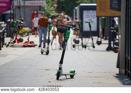 Bucharest, Romania - July 25, 2019: Several Lime-s Electric Scooters Are Parked On A Sidewalk In Buc