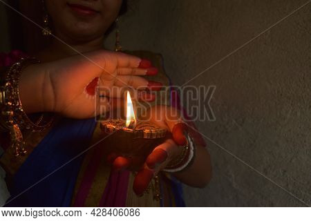 An Indian Woman Devotee Lights Lamps And Celebrated The Diwali Or Deepavali Festival. Concept Of The