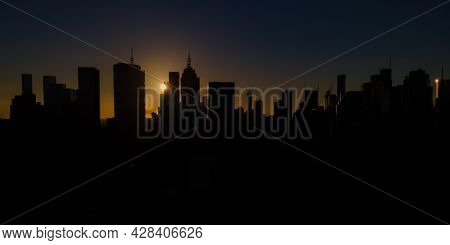 Melbourne City Skyline Silhouetted By A Dramatic Sunset