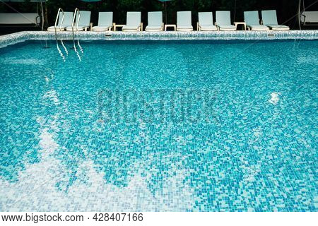Empty Swimming Pool With Blue Mosaic Tiles Without People. A Place For Summer Vacations And Relaxati