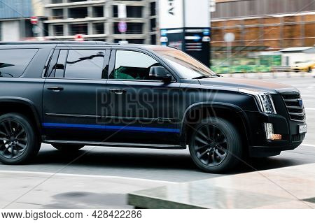 Moscow, Russia - April 2021: Black Cadillac Escalade Car Moving On The Street On High Speed. Fast Mo