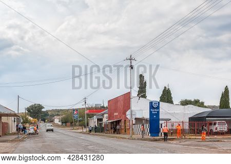Steynsburg, South Africa - April 22, 2021: A Street Scene, With Businesses, People And Vehicles, In 
