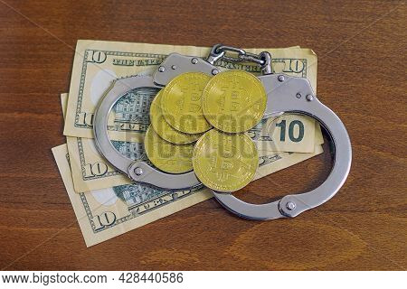 Golden Bitcoins Cryptocurrency With Handcuffs On Dollar Bills. Digital Crime, Arrest Or Hacking Conc