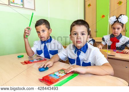 Krasnodar, Russia - September 1, 2020: First-form Schoolchildren In Classroom At School Desks On Hol