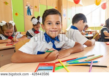 Krasnodar, Russia - September 1, 2020: First-form Schoolchildren In Classroom At School Desks On Hol