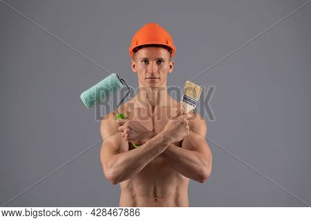 Sexy Man With Muscular Torso Hold Paintroller And Paintbrush For Decorating And Painting, Painter